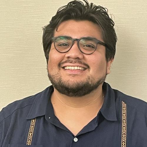 Latino man smiling with glasses